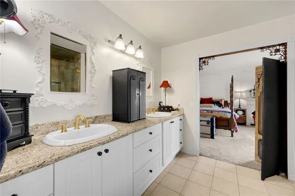 a bathroom with a sink vanity tub and shower