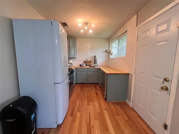 a kitchen with a sink and refrigerator