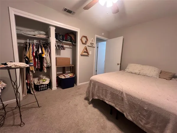 a bedroom with a bed and a walk in closet