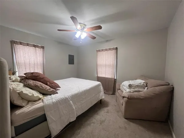 a bedroom with bed and window
