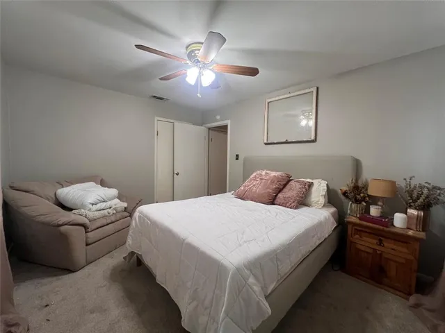 a bedroom with bed and window