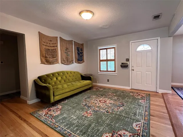 a living room with furniture and a rug