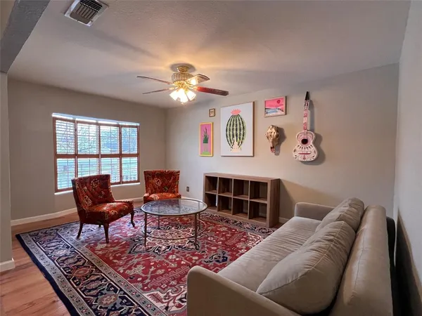 a living room with furniture a rug and a window