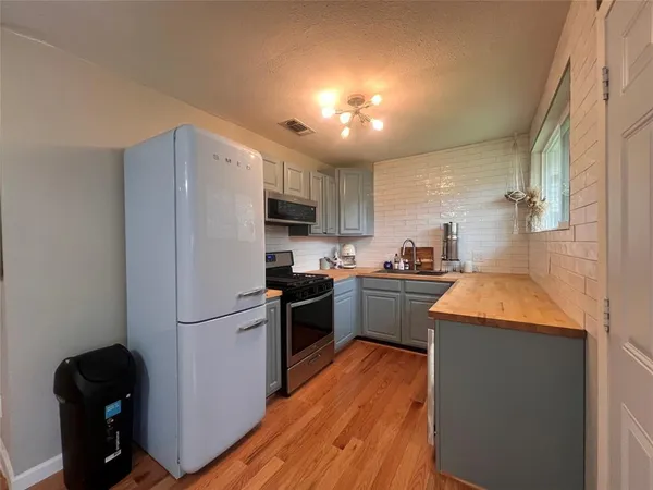 a kitchen with a refrigerator a stove top oven a sink and dishwasher