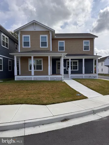 a view of a brick house with large windows