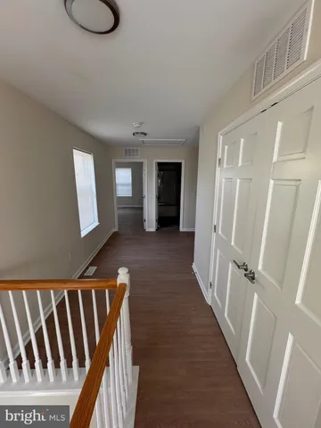 a view of a kitchen with wooden floor and washing machine