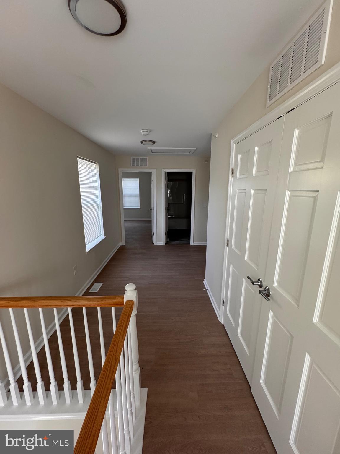 638 Douglas Street Cambridge, MD 21613 - Photo 17 of 30 a view of a hallway with wooden floor and stairs