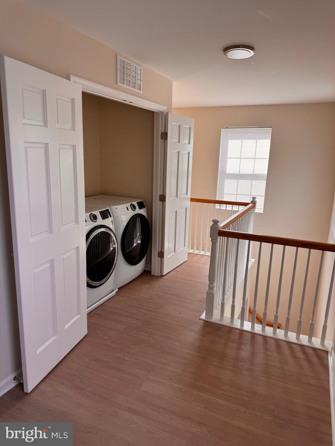 638 Douglas Street Cambridge, MD 21613 - Photo 18 of 30 a view of a kitchen with wooden floor and washing machine