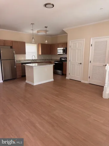 a large kitchen with cabinets and stainless steel appliances
