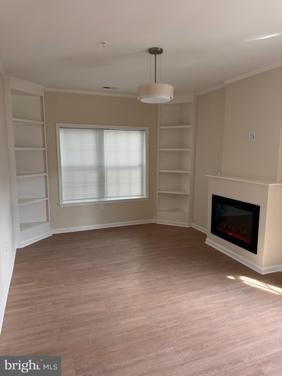 638 Douglas Street Cambridge, MD 21613 - Photo 5 of 30 a view of an empty room with a fireplace and a window