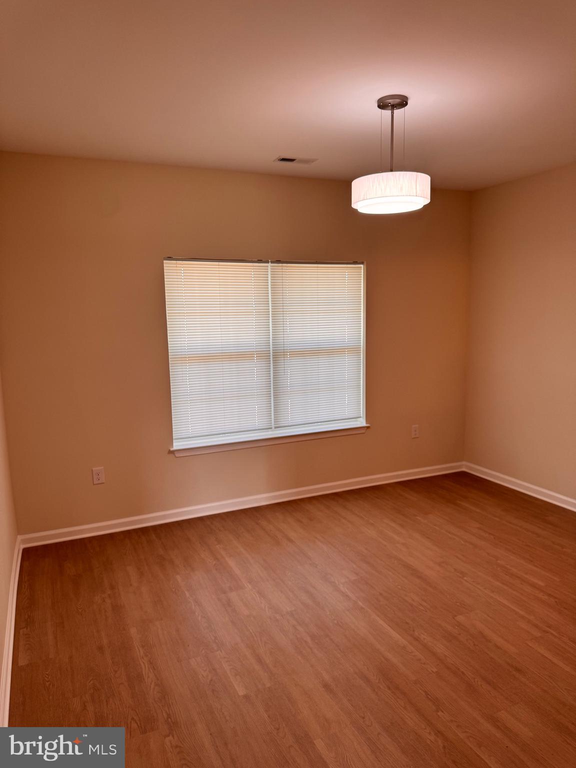 638 Douglas Street Cambridge, MD 21613 - Photo 7 of 30 a view of an empty room with wooden floor and a window