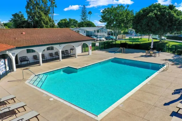 swimming pool view with a seating space