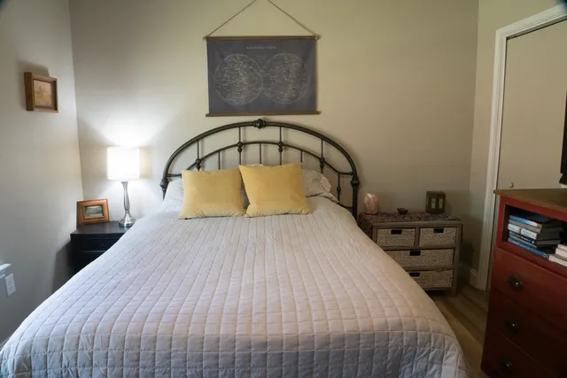 a bedroom with a bed and a television