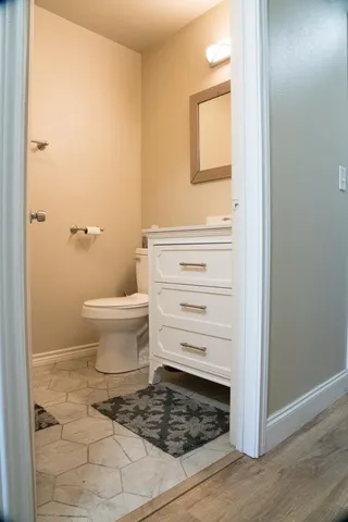 a bathroom with a toilet and a mirror