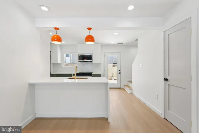 a kitchen with cabinets and window