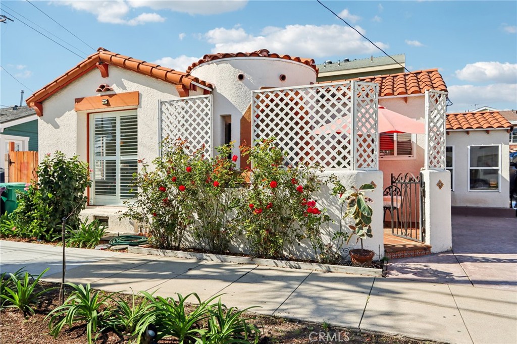 a front view of a house with a garden