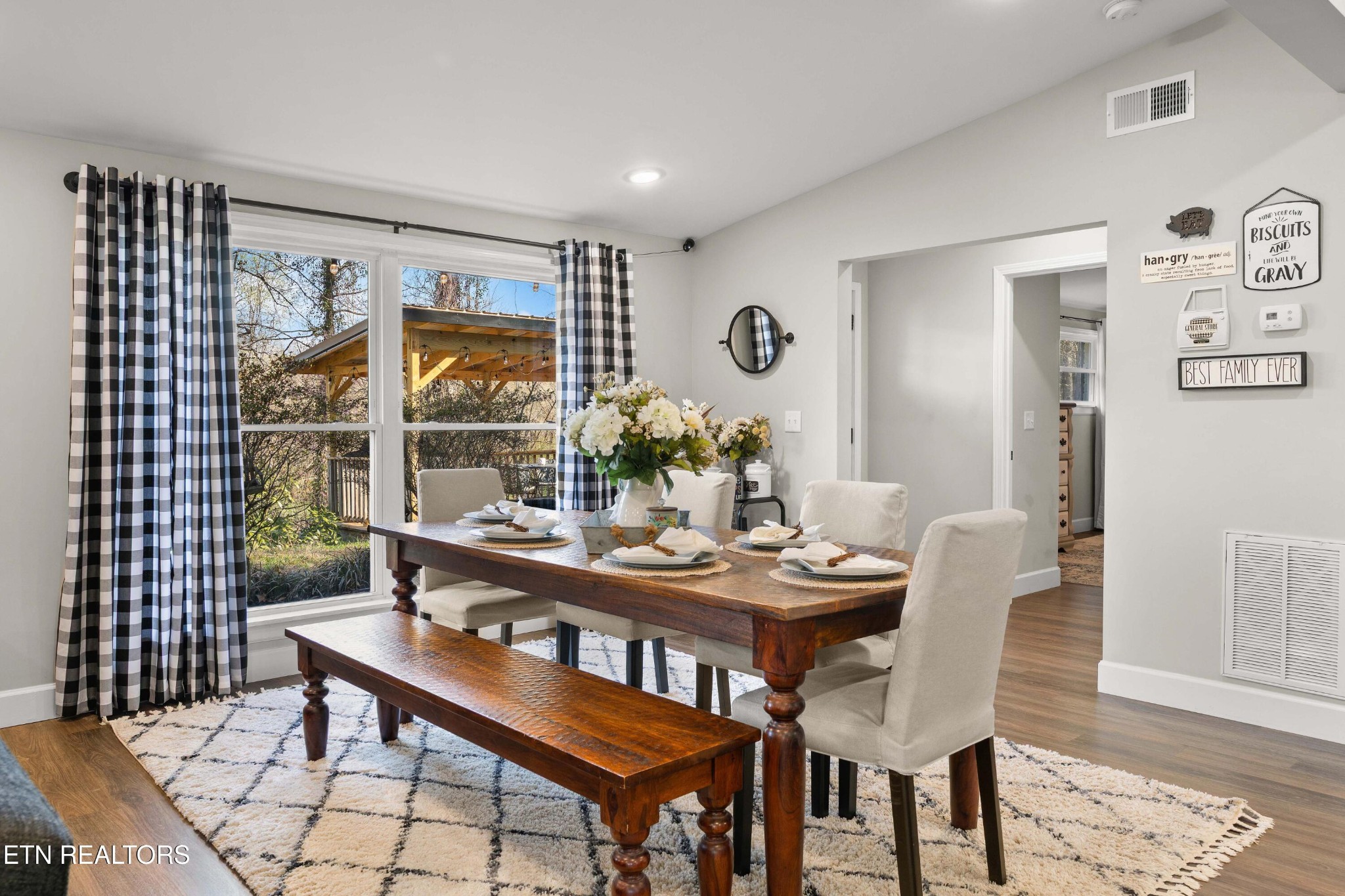 507 Short Street Athens, TN 37303 - Photo 16 of 54 a view of a dining room and livingroom with furniture wooden floor and a rug