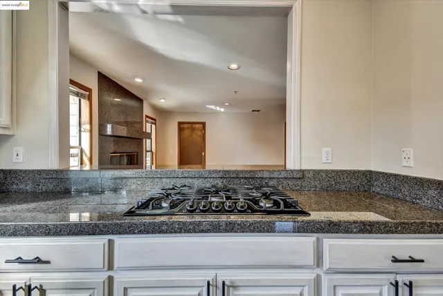 a bathroom with a granite countertop sink and a granite counter top