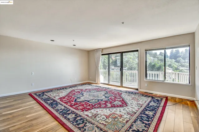 a large bed sitting in a bedroom next to a window