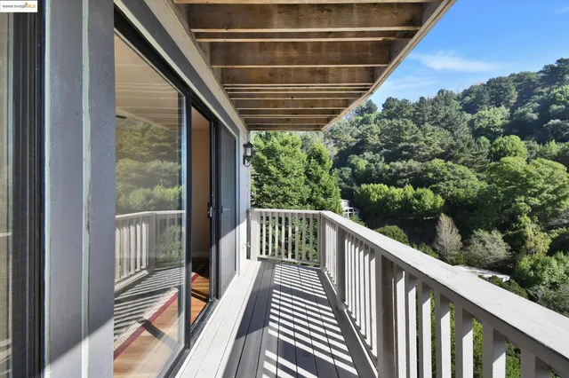a view of balcony with wooden floor and fence