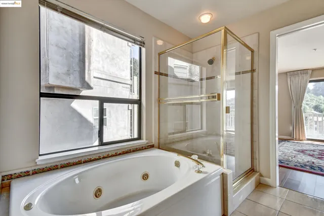 a bathroom with a tub and a shower