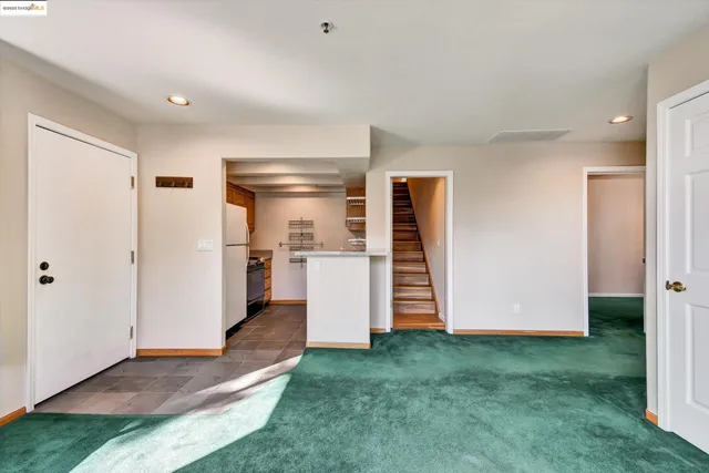 a view of kitchen with a refrigerator and a sink