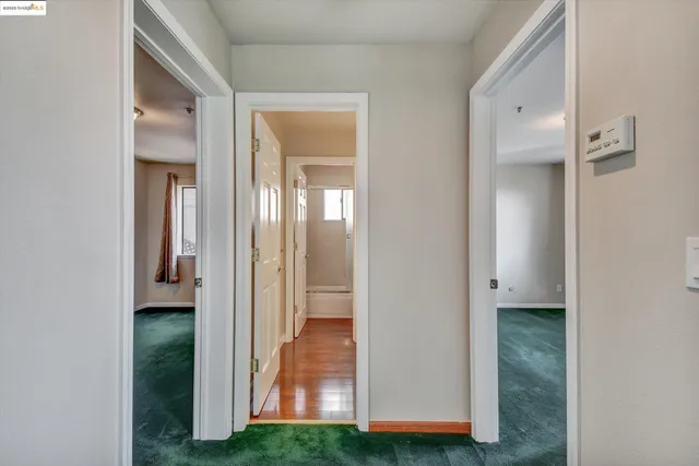 a view of a bathroom from a corridor