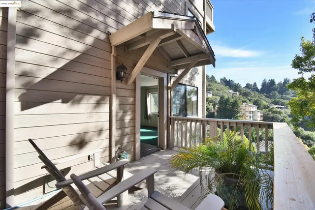 a view of a chair and tables in the balcony