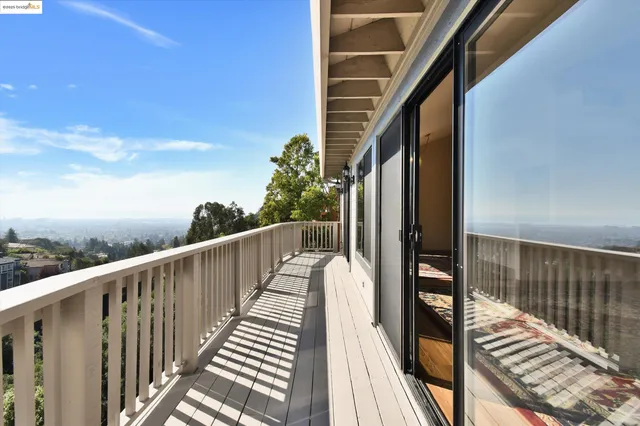 a view of balcony with wooden floor and fence