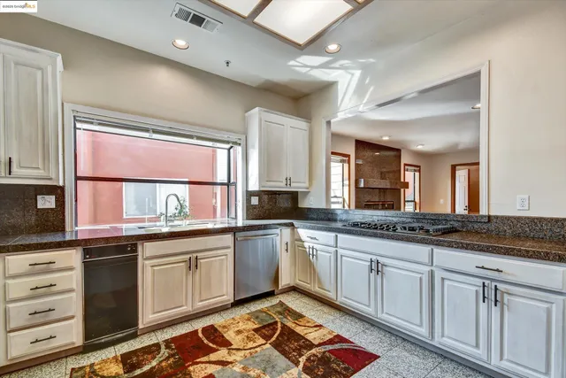a kitchen with a sink stove and cabinets