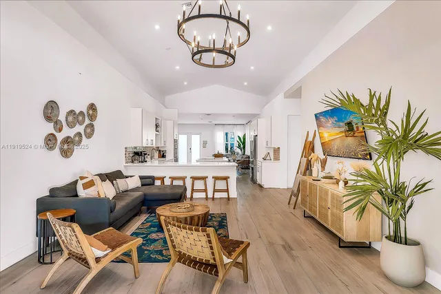 a view of a dining room with furniture wooden floor and chandelier