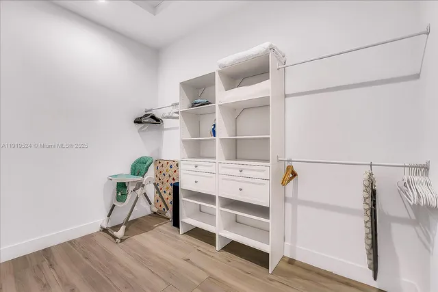 a view of walk in closet with empty racks