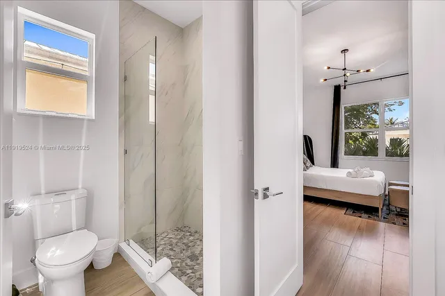 a bathroom with a toilet tub and a shower