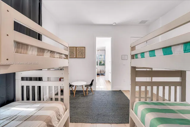 a bed room with a bed and a chair