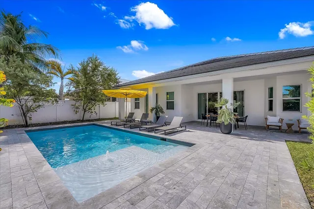 a view of a backyard with plants and a patio