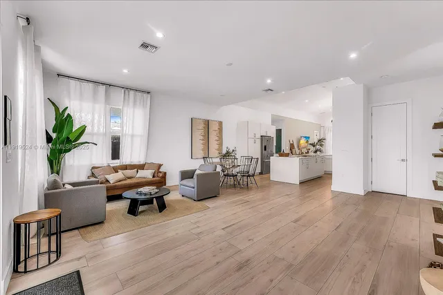 a living room with furniture or wooden floor and a potted plant
