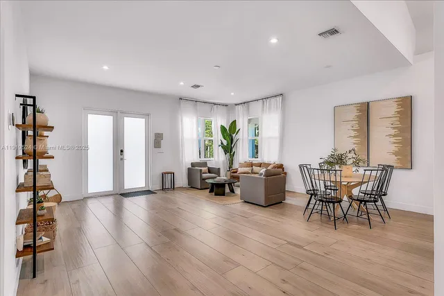 a living room with furniture a wooden floor and a window