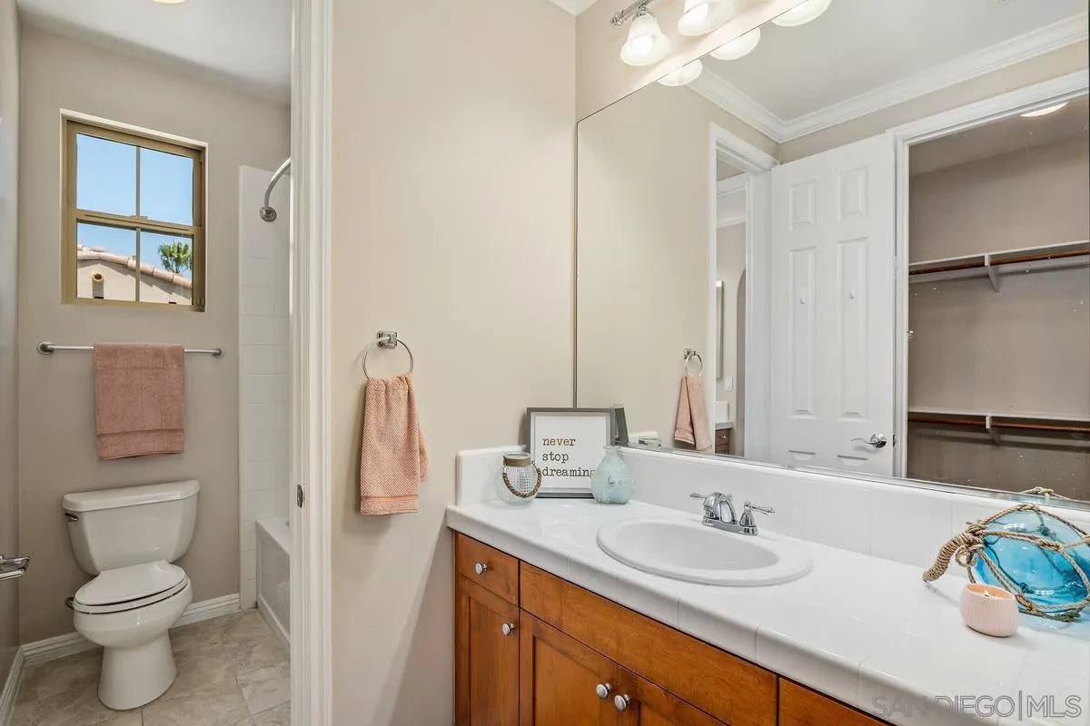 2740 East Bainbridge Road San Diego, CA 92106 - Photo 27 of 30 a bathroom with a granite countertop sink toilet and shower