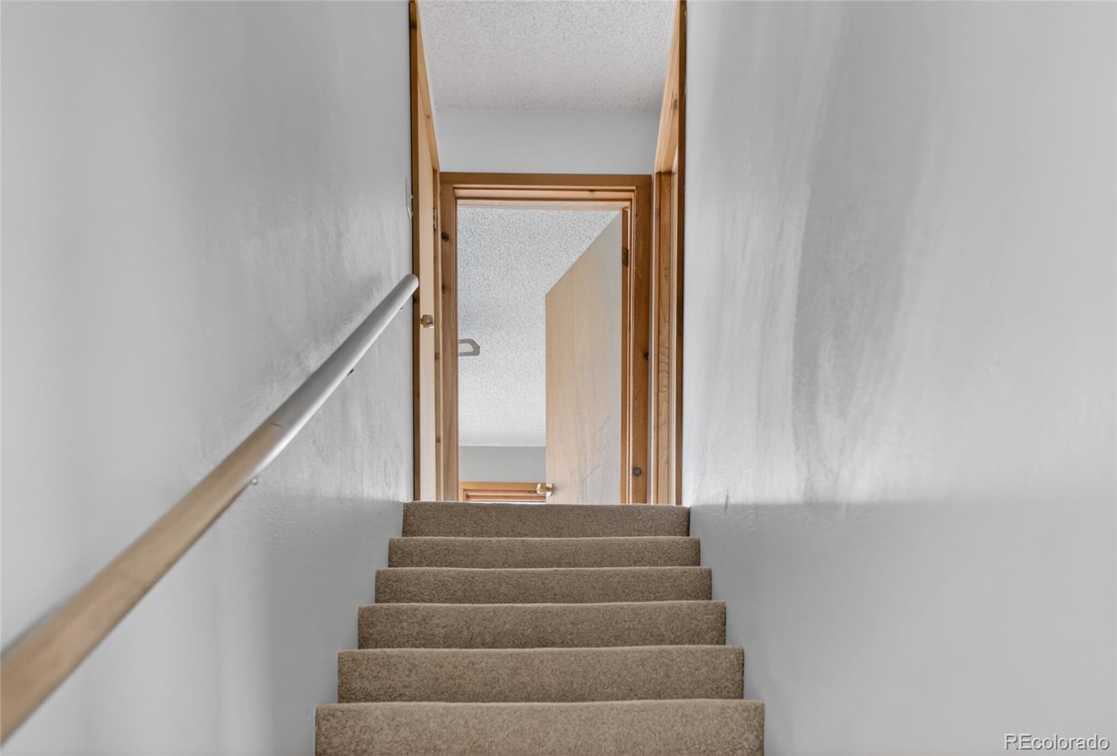 34425 County Road Alamosa, CO 81101 - Photo 25 of 34 a view of staircase with white walls and a window