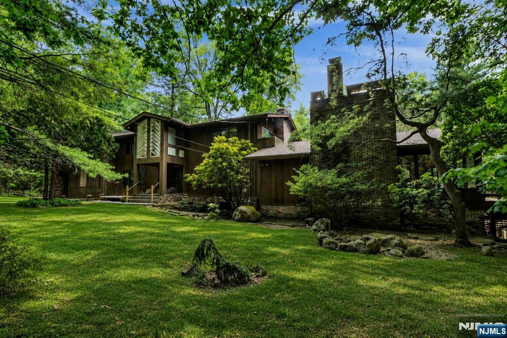 a view of a house with a yard and sitting area