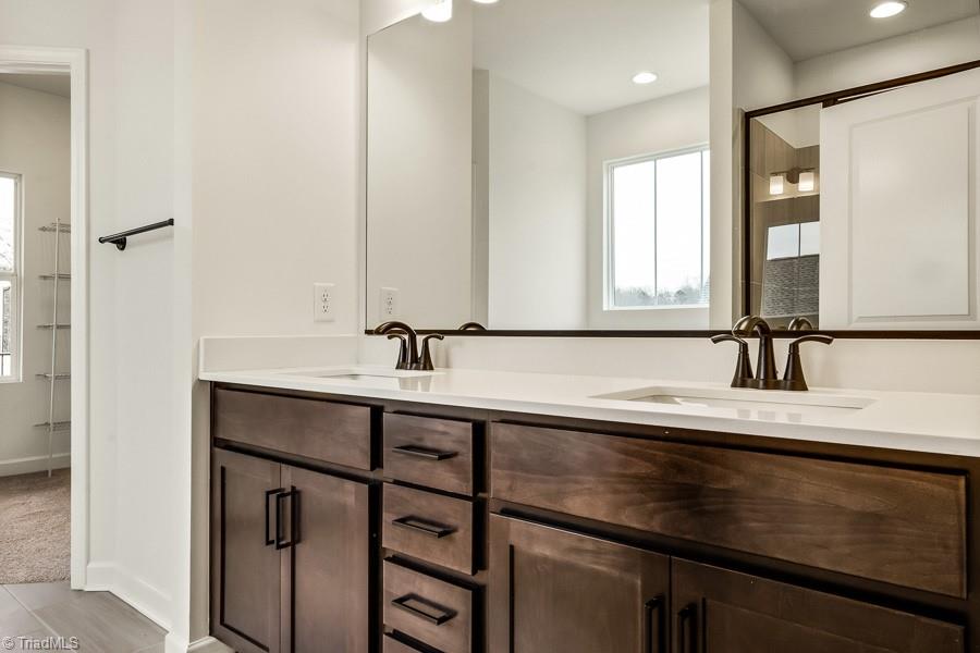 7714 Sedgewick Ridge Road Lewisville, NC 27023 - Photo 21 of 43 Primary Bath w/ Double Vanity, Black Accents & Quartz