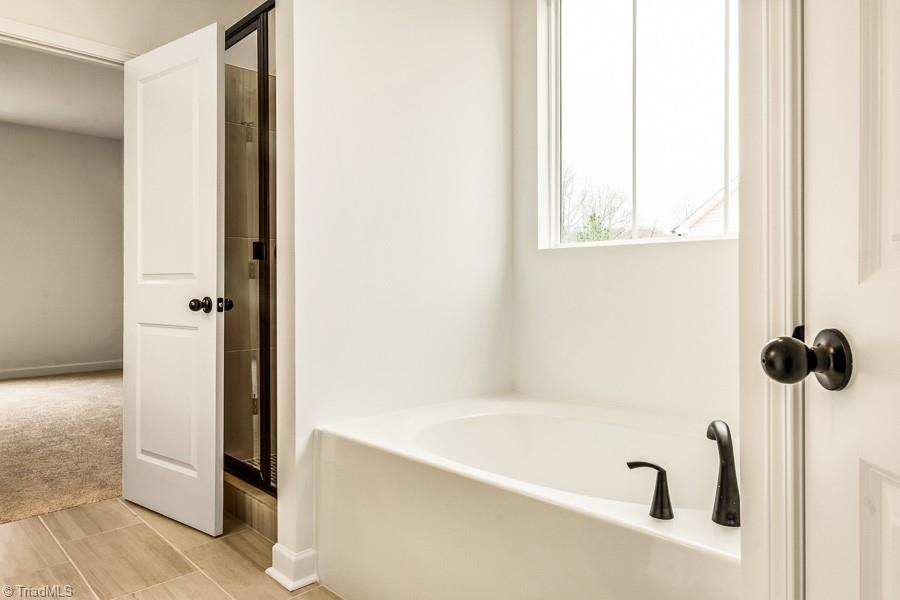 7714 Sedgewick Ridge Road Lewisville, NC 27023 - Photo 22 of 43 Beautiful Garden Tub + All Tile Shower
