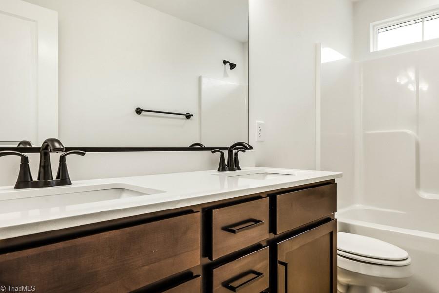 7714 Sedgewick Ridge Road Lewisville, NC 27023 - Photo 36 of 43 Upstairs Full Bath w/ Double Vanity & Black Accents
