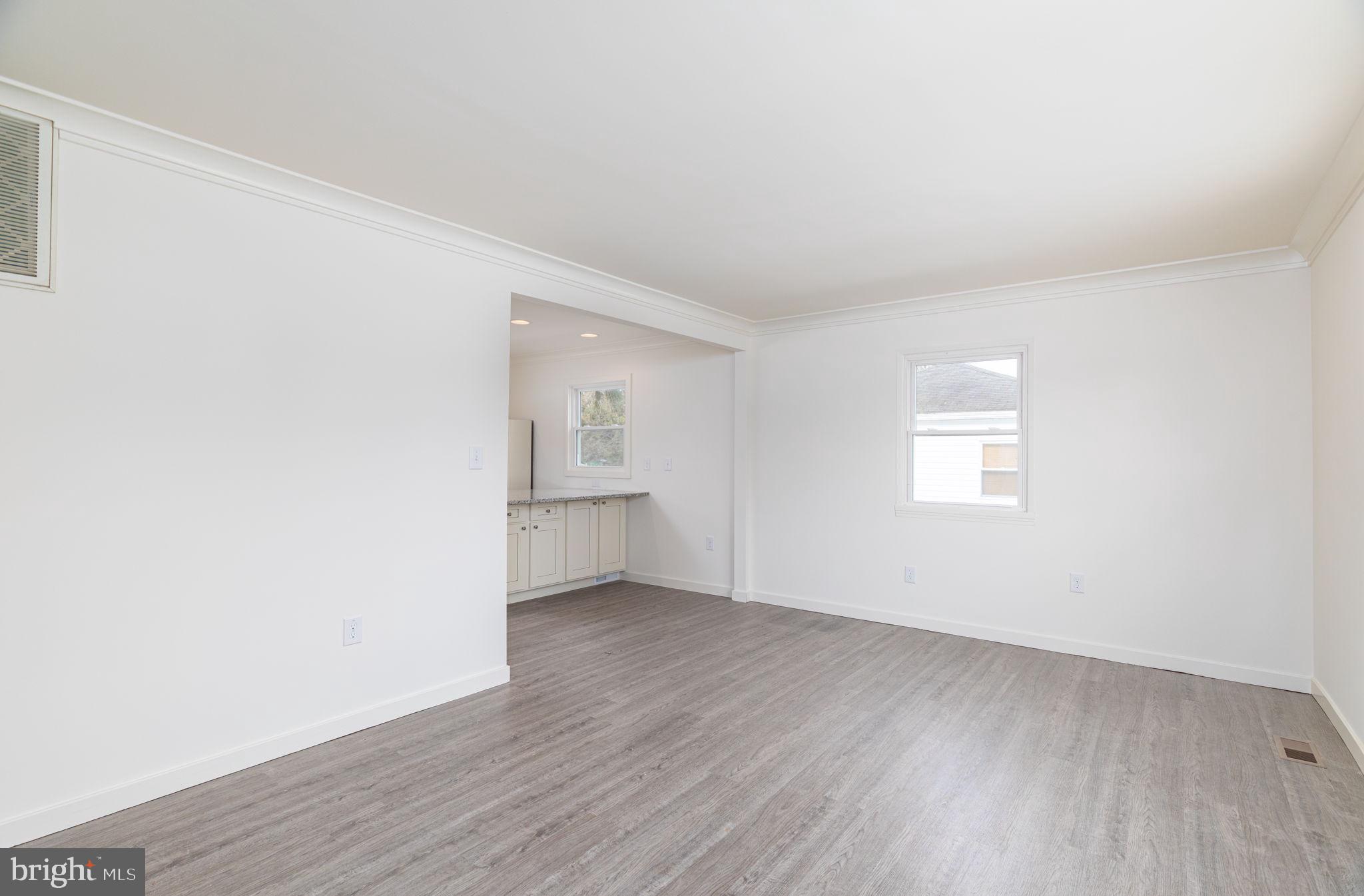 8 South Reed Street Bel Air, MD 21014 - Photo 5 of 21 an empty room with wooden floor and windows
