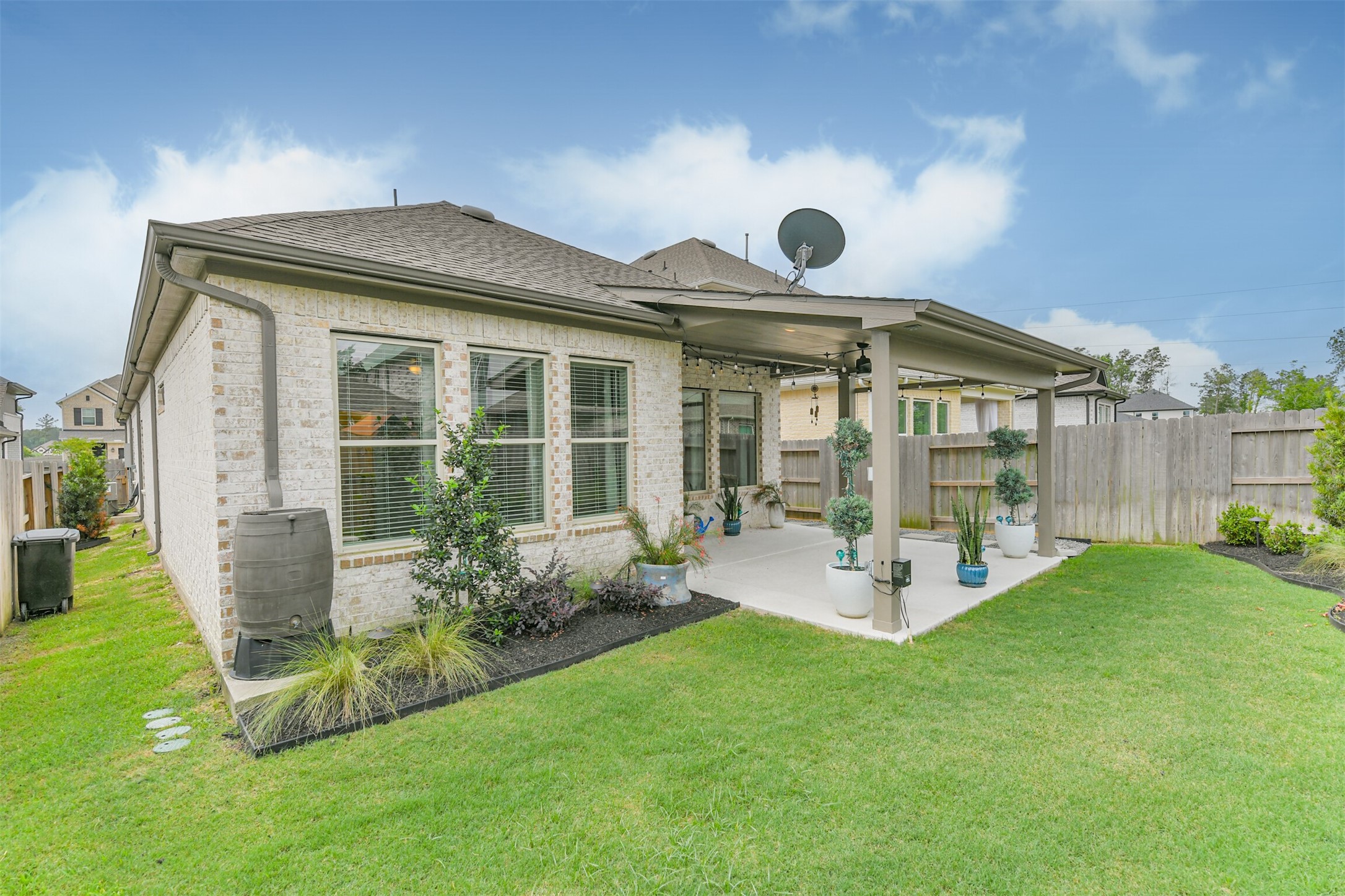 15611 Rising Wren Court Conroe, TX 77302 - Photo 25 of 38 a view of a house with backyard sitting area and garden