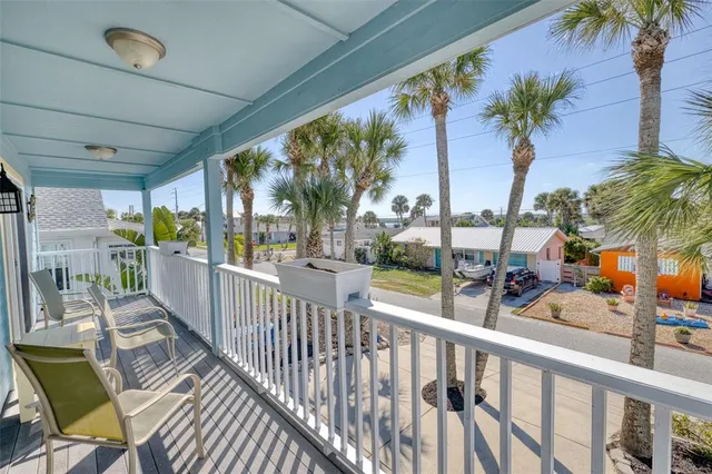 a view of a balcony with dining area and glass door