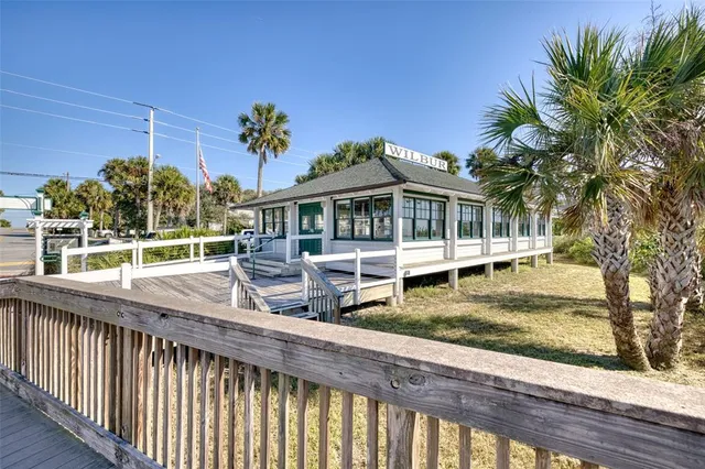 an outdoor view of the house and cars parked