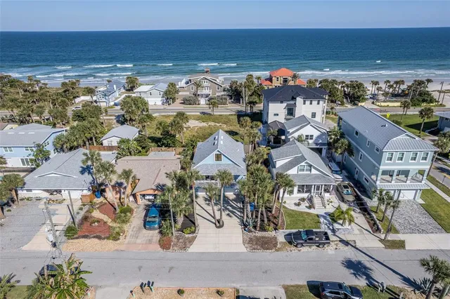 an aerial view of a houses with a lake