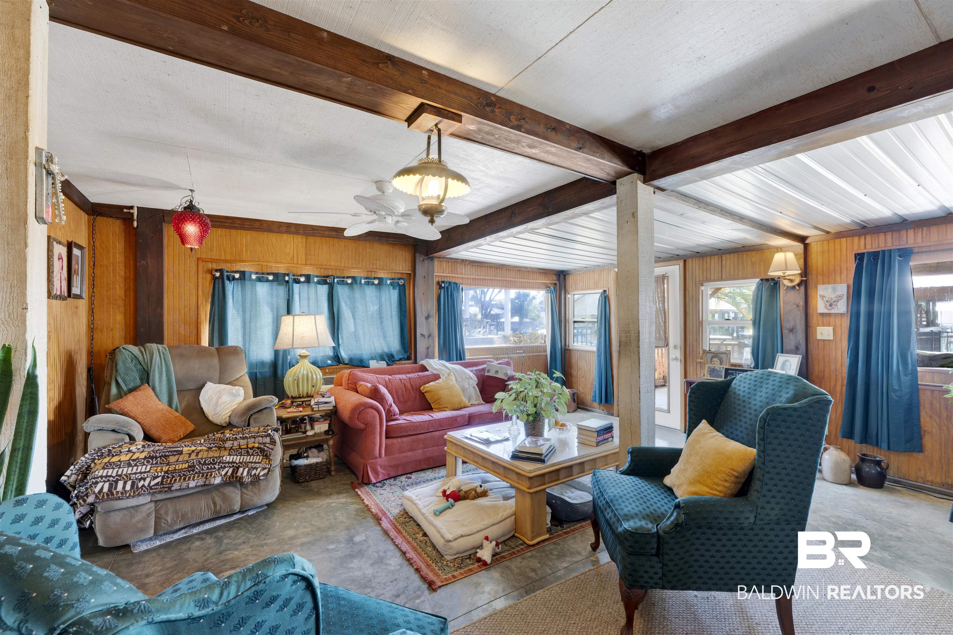 26222 Marina Road Orange Beach, AL 36561 - Photo 27 of 38 Living room with wooden walls and beam ceiling