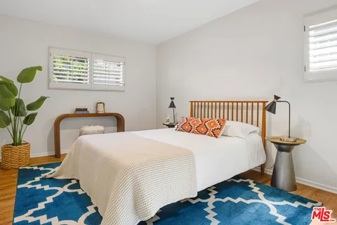a bedroom with bed and a window